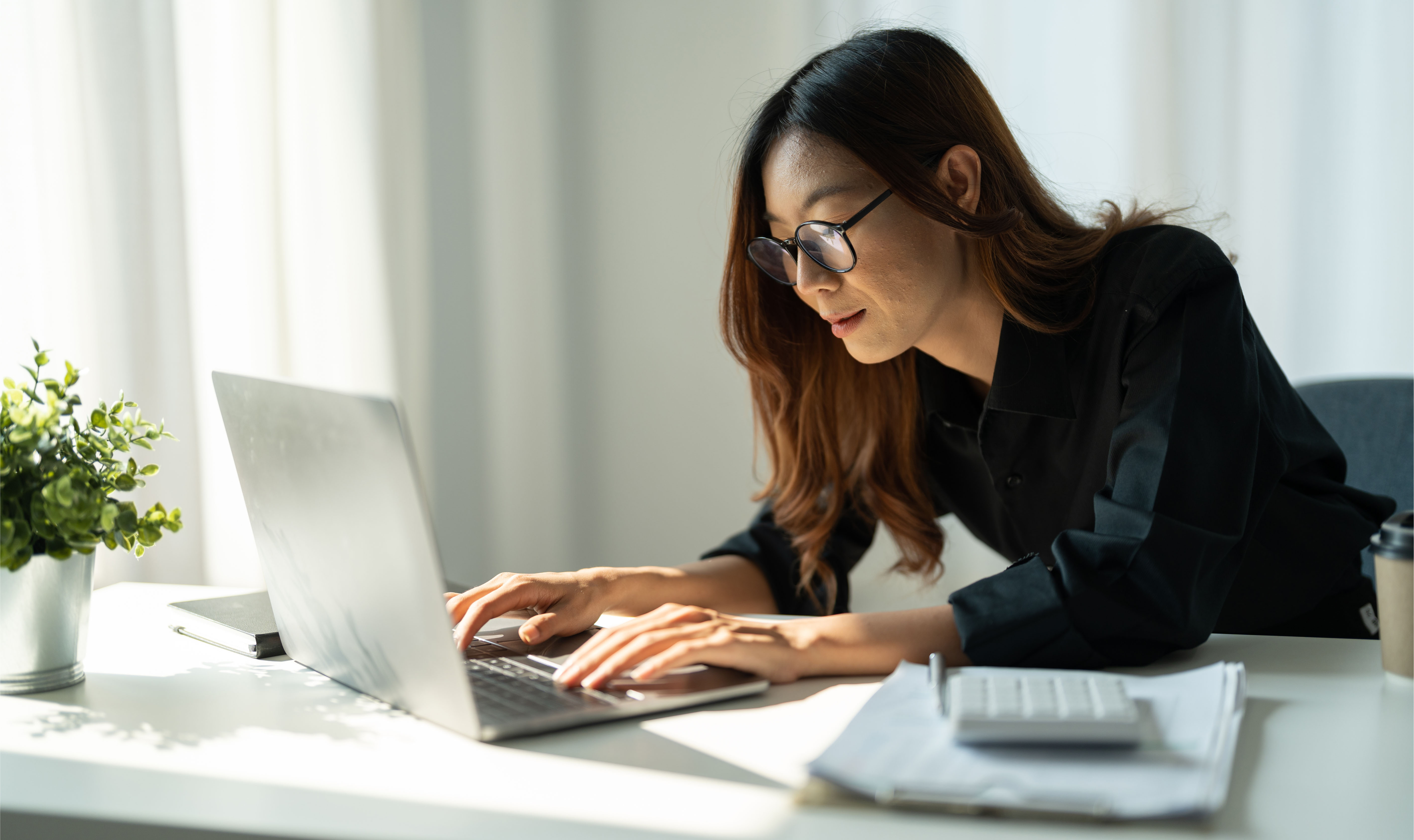 Young Asian business woman working on laptop