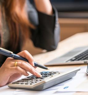 Accountant calculating at desk - Accountant Professional Indemnity - Howden Belgium