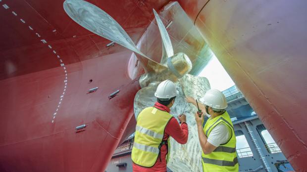 Men fixing a ship's hull 