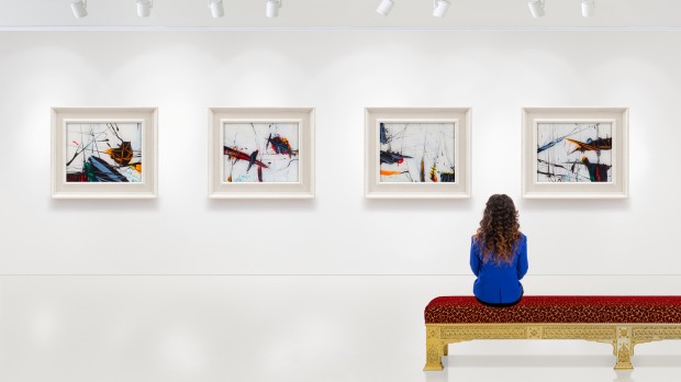 Lady observing artwork in an empty gallery