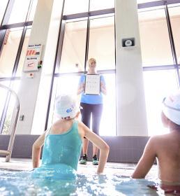 Young swimmers and swimming teacher