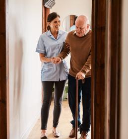 Carer helping an elderly man