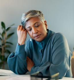 A woman suffering from anxiety while working in her office