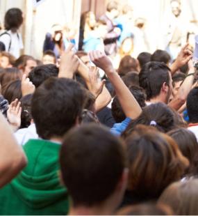 A crowd of people fill a street at a political march