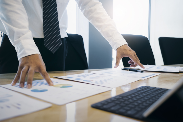 Man with several pieces of paper in front of him
