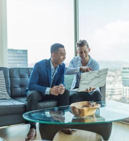 happy client in the office talking to businessman