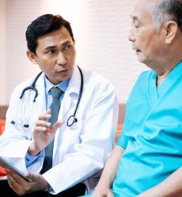 A doctor with an elderly patient explaining notes