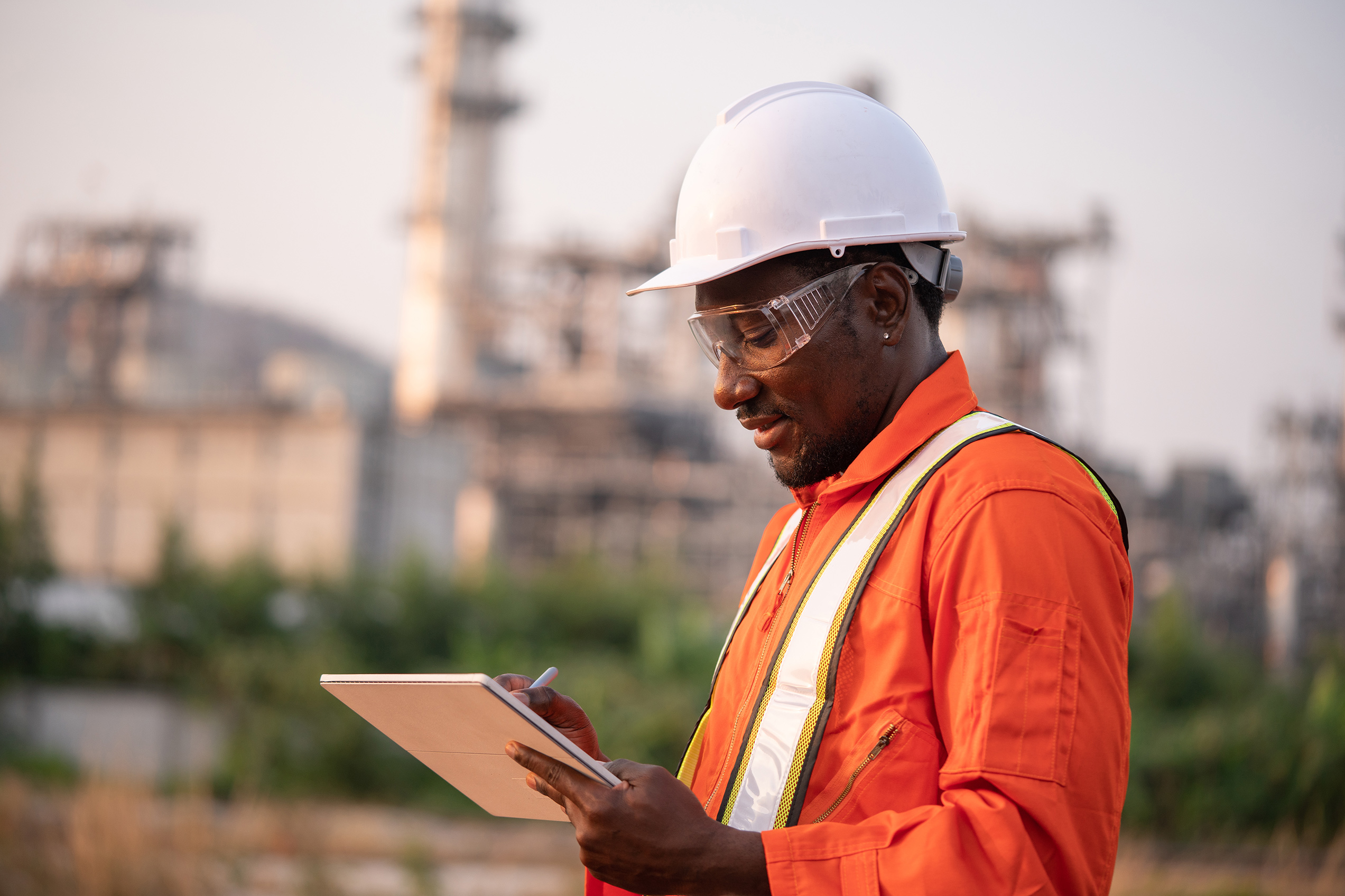 Engineer writing on a pad at a construction site