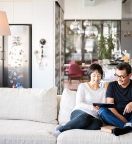 A cheerful couple relax in their large open-plan home