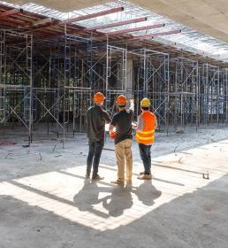 Three construction workers in a discussion