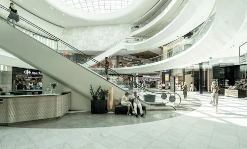 Escalator in mall with retail shops