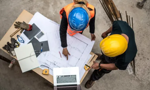 Two construction workers discussing a plan