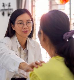 Doctor comforting female patient