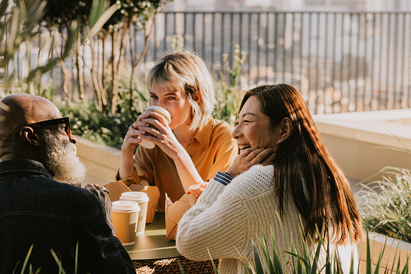 three friends drinking coffee together