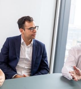 surety team at Howden UK brokers talking in a meeting - meet the team