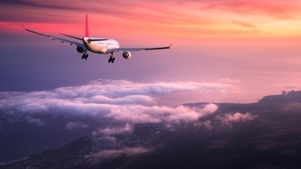 Aeroplane in the sky at sunset Aeroplane in the sky