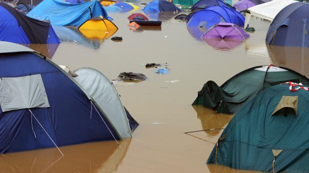 Event Cancellation Tents sit in deep muddy flood water