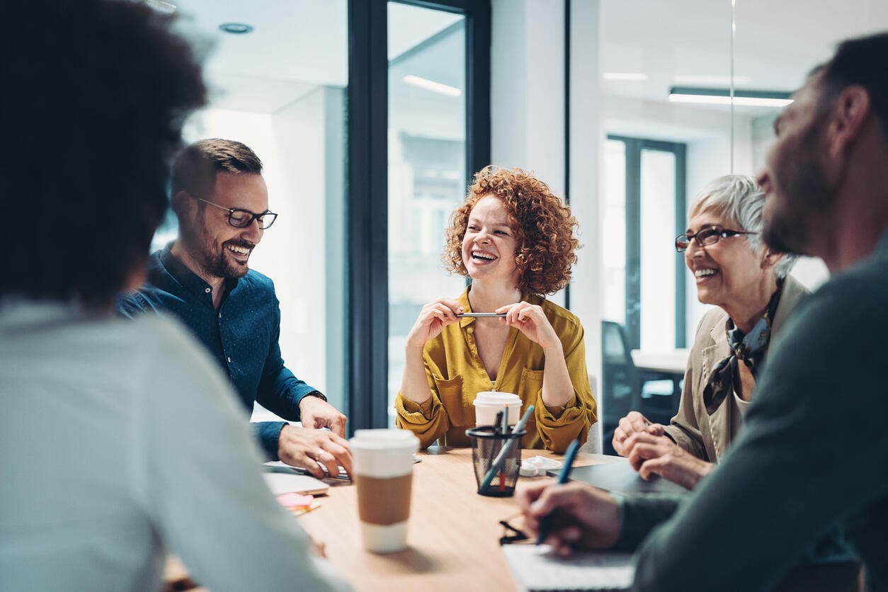 people laughing together around a table