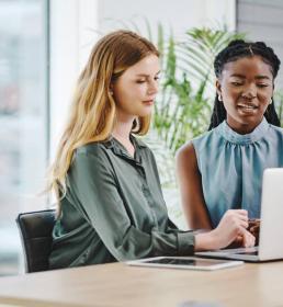 Two people looking at a laptop