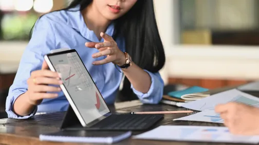 Woman presenting the data on a ipad