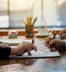 Two businessmen signing a contract