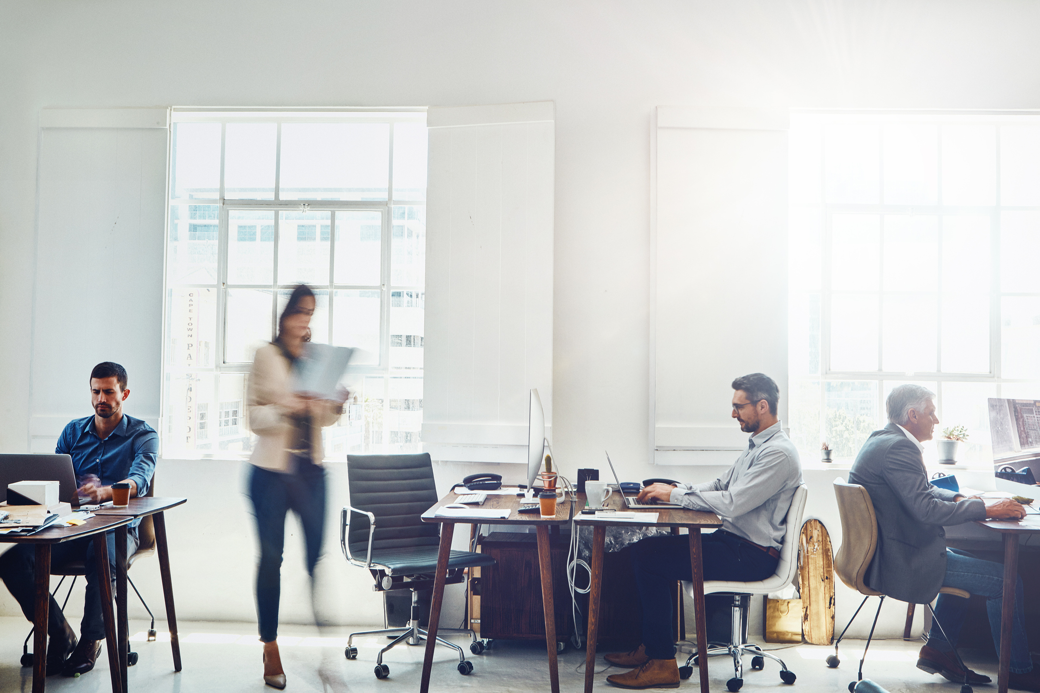 Young professionals work in an open plan office