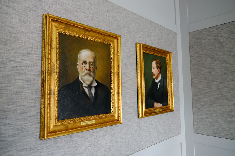 Two fine art paintings on office wall