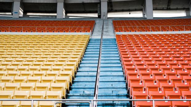 Event cancellation A view from the pitch of rows of empty stadium seats