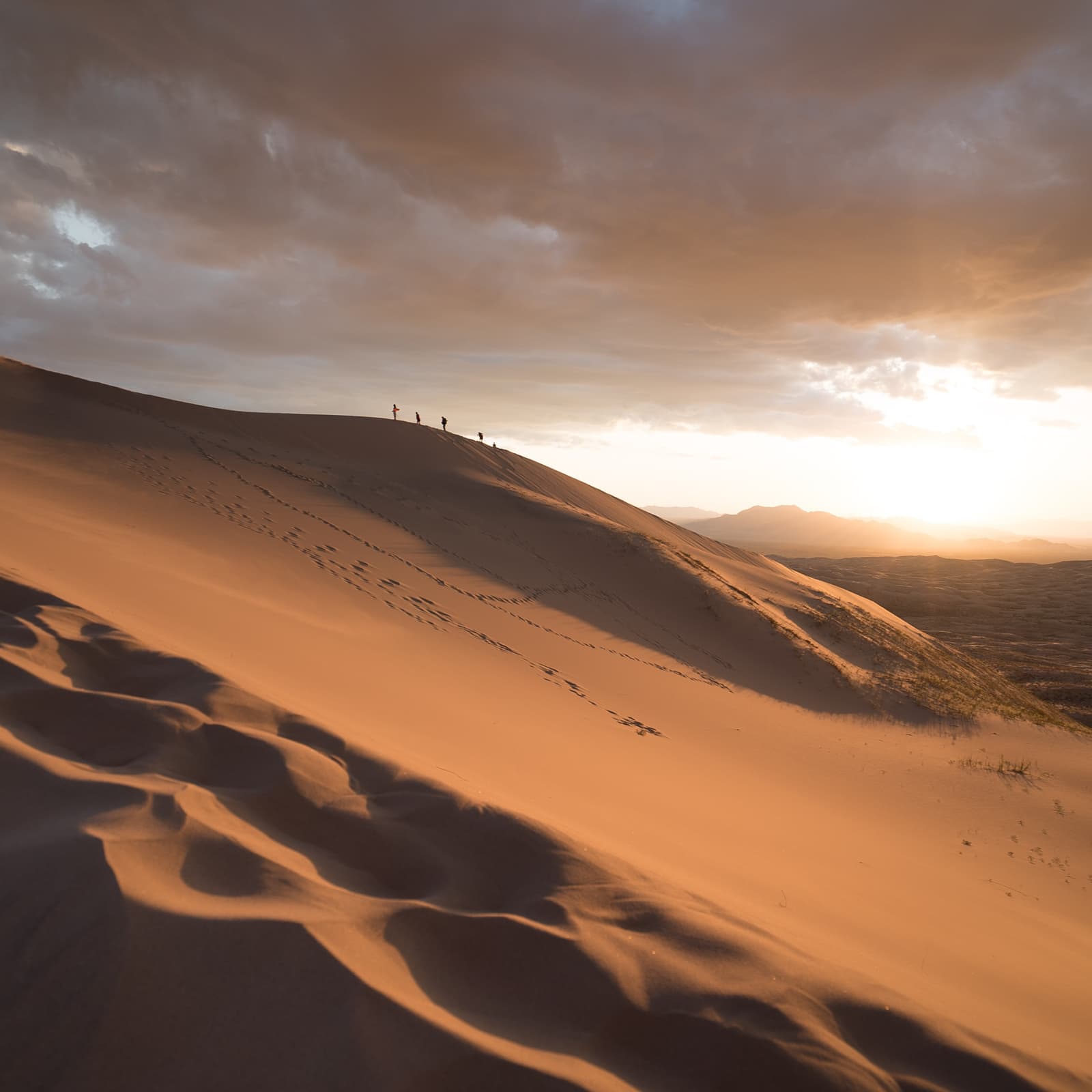 People walking throughout a desert