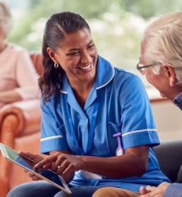 Care home worker talking to resident