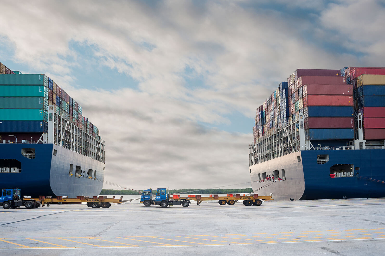 Cargo container ships docked at shipping port with stacked freight containers, maritime logistics operations, and global import export transportation industry.