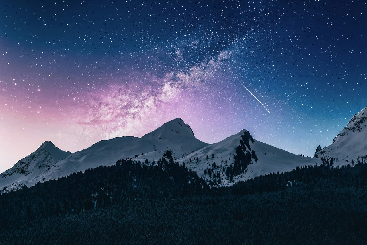 Snow covered mountains at night